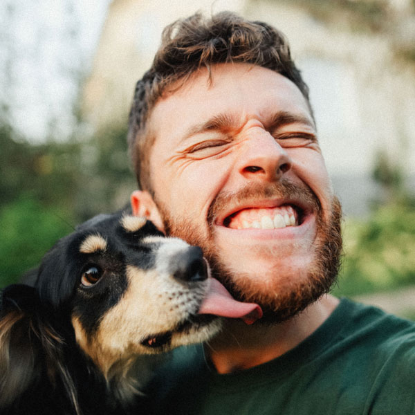 selfie of a man smiling with his dog