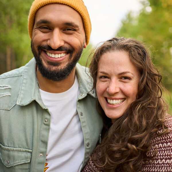 Laughing young couple standing on a country road