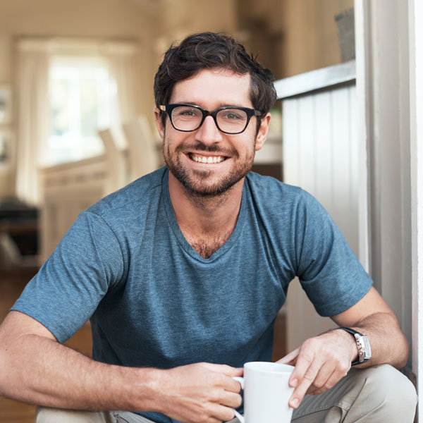 young man enjoying a cup of coffee in the morning